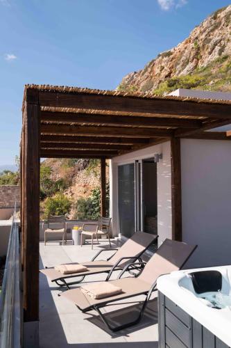 a group of chairs on the roof of a house at See2sea Cozy Apartments in Kolymvari