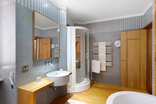 a bathroom with a sink and a shower and a mirror at Divina Vietri in Vietri sul Mare