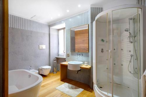a bathroom with a tub and a sink and a shower at Divina Vietri in Vietri sul Mare