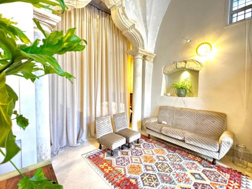 a living room with a couch and a rug at Casa Cesira, antica dimora con cucina professionale - Marea Stays Collection in Nardò