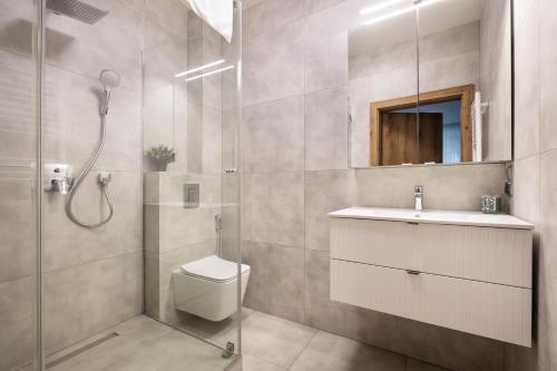 a bathroom with a shower and a toilet and a sink at Nowy Hotel Monika - by Upstairs in Kraków
