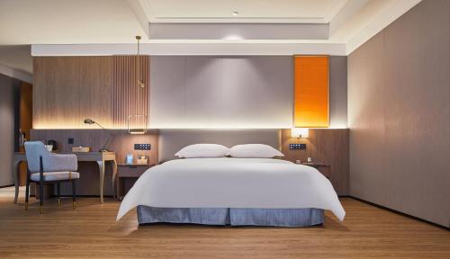 Harriway Garden Hotel Houjieにあるベッド