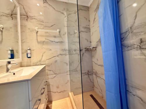 a bathroom with a shower and a sink at Hotel Venus in Mamaia