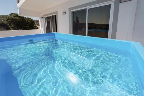 a large blue hot tub in a room with a window at Sinani Villas Rhodes - Afantou Private Retreats in Afantou