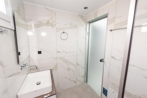 a bathroom with a sink and a shower at Sinani Villas Rhodes - Afantou Private Retreats in Afantou