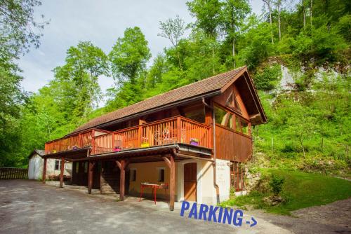 a building with a deck on the side of it at ECO-CHALET Bel Oiseau - Saint-Ursanne in Saint-Ursanne