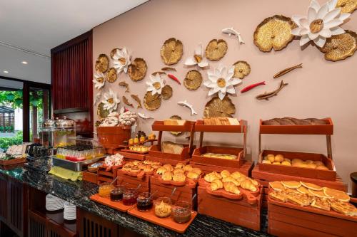 a bakery with a display of bread and pastries at Silk Sense Hoi An River Resort - Green Luxury Escape in Hoi An