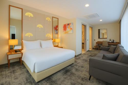 a bedroom with a bed and a living room at Tryp by Wyndham Istanbul Topkapi in Istanbul