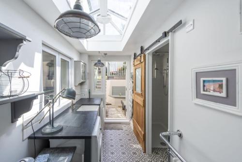 a home office with a skylight and a hallway with a desk at Almond Cottage - Pets welcome - Free Parking - Garden in Hayle
