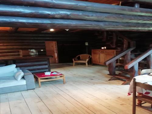an attic room with a couch and a table at Charming Chalet with Swimming Pool in Quend in Quend