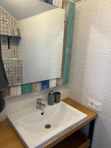a bathroom with a white sink and a mirror at ДЗЕН Garden in Fontanka
