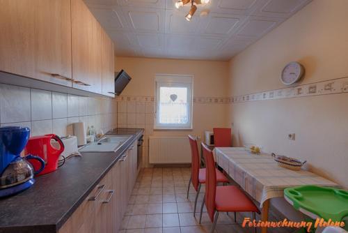 a kitchen with a table with chairs and a counter top at Helene in Hüttenrode