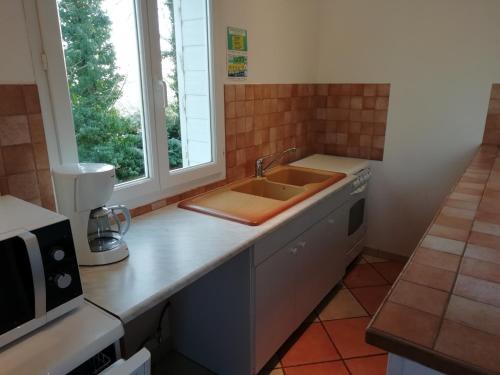 a kitchen with a sink and a counter top at Charming Chalet with Swimming Pool in Quend in Quend