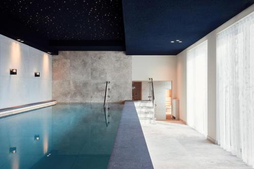 a swimming pool in a room with a swimming pool at Van der Valk Hotel Gorinchem-A15 in Gorinchem