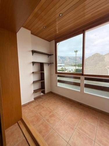 a large room with a large window and a view at Soleado y acogedor con piscina privada in L’Alfàs del Pi