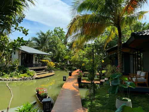 a house by the water with a wooden walkway at Annhien home's in Phan Rang–Tháp Chàm