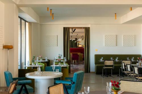 a restaurant with blue chairs and tables and tablesktop at Stars by Castor & Pollux in Tbilisi City