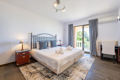 a bedroom with a large bed and a large window at Grand Villa! with Golf & Sea view!! in Marbella