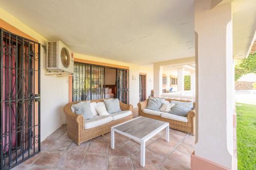 a porch with two couches and a coffee table at Grand Villa! with Golf & Sea view!! in Marbella