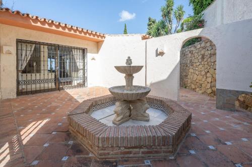 a fountain in the courtyard of a house at Grand Villa! with Golf & Sea view!! in Marbella