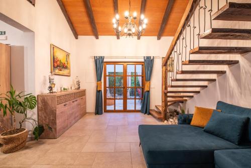 a living room with a blue couch and stairs at Villa Ilir in Neum