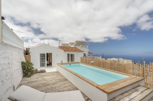 a house with a swimming pool and a fence at Casa Xuixo in Tenerife South in Guía de Isora