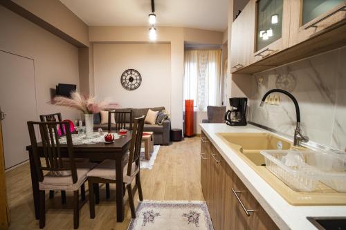 a kitchen and living room with a table and a couch at Mary's cozy apartments in Pýrgos