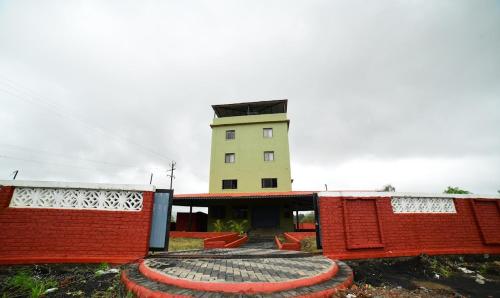 a building with a circle in front of it at Hotel Highway Nest Igatpuri in Ghoti Budrukh