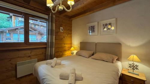 Ένα ή περισσότερα κρεβάτια σε δωμάτιο στο Chaleureux appartement 10pers Sainte-Foy-Station