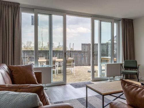 a living room with sliding glass doors at Unique vacation home in Offingawier