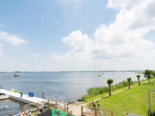 a view of a large body of water with boats at Unique vacation home in Offingawier