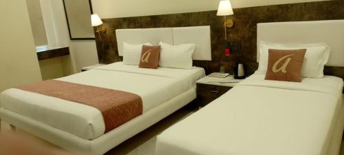 Ένα ή περισσότερα κρεβάτια σε δωμάτιο στο Astra Hotels and Suites - Sector 7 HSR Layout