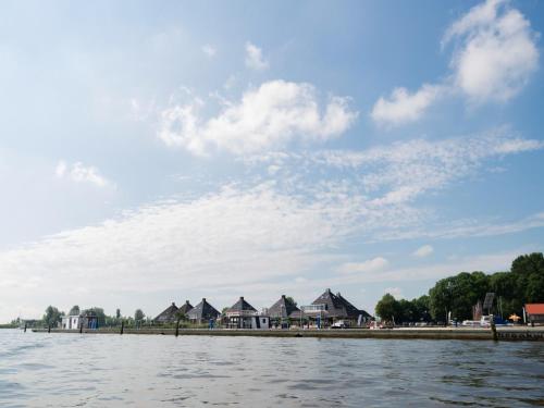 a body of water with houses in the background at Unique vacation home in Offingawier