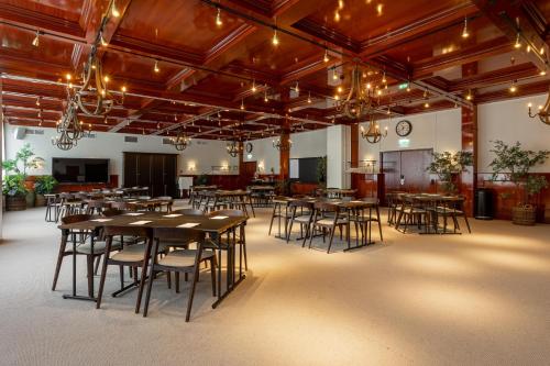 a large room with tables and chairs in it at Ystad Saltsjöbad in Ystad