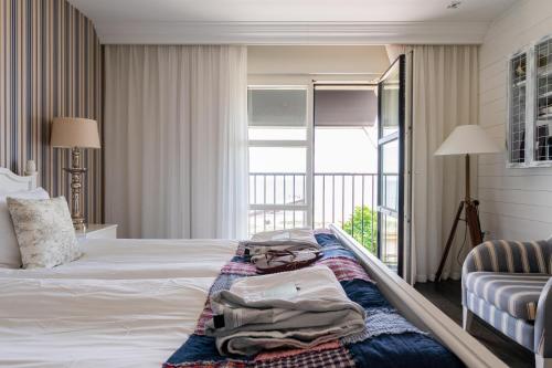 a hotel room with a bed and a balcony at Ystad Saltsjöbad in Ystad