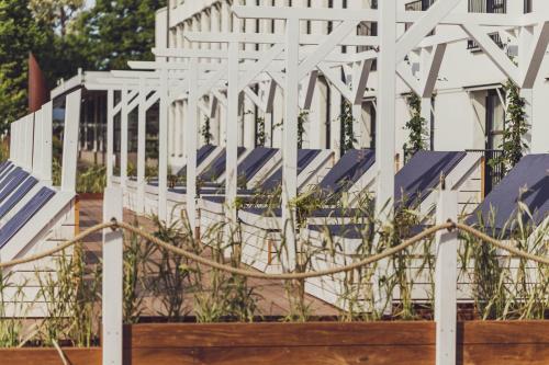 a white fence with some plants in front of it at Ystad Saltsjöbad in Ystad