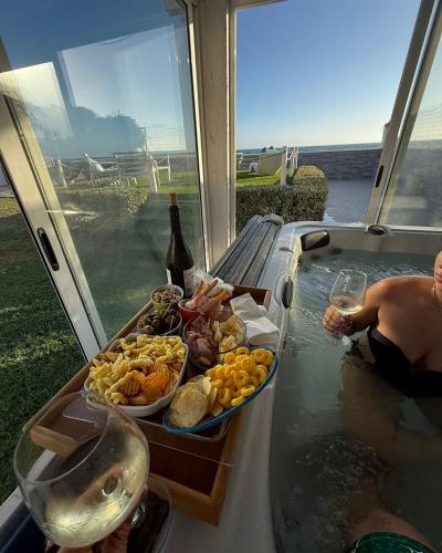 a table with a tray of food and a bottle of wine at SUITEBEACH b&b and resort in Marsala