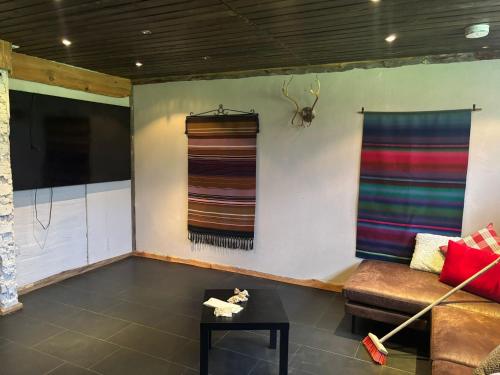 a living room with a couch and a window at Chalet Päämaja Rovaniemi in Rovaniemi