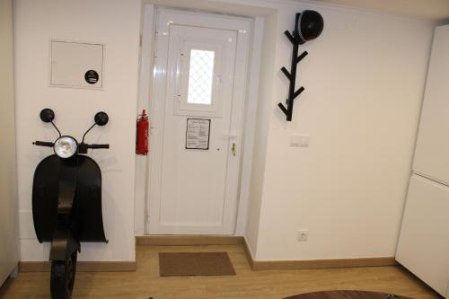 a scooter parked in a room next to a door at Cozy Apartment Elvas II in Elvas