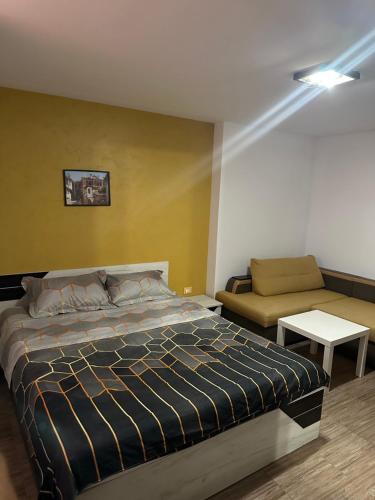 a bedroom with a bed and a couch at Guest Rooms Comfort 2 City Center in Plovdiv