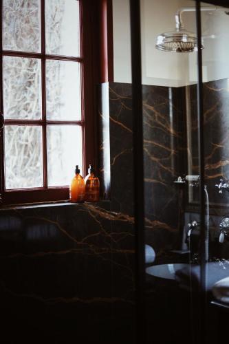 a bathroom with two pumpkins on a counter next to a window at Domaine Saint Clair - Le Donjon in Étretat