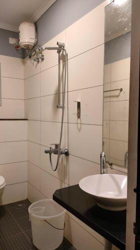 a bathroom with a sink and a shower at Royal Service apartment - KK Nagar Madurai in Madurai