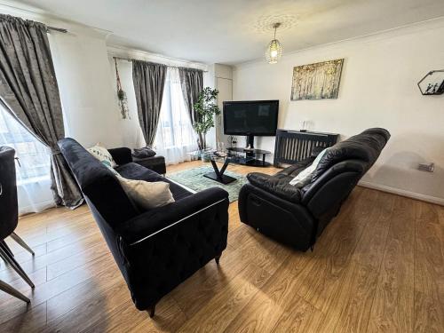 a living room with two couches and a television at Spacious Beautiful London 2 Bedroom Apartment - 2 Bathrooms 1 Parking in London