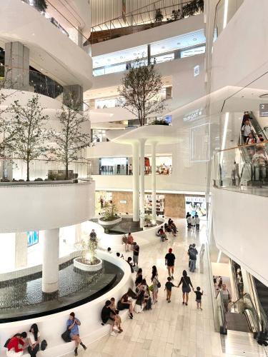 a group of people sitting in a shopping mall at HausKomma 서울 홍대,이태원,명동 짐보관 무료 주차 엘레베이터 새아파트 in Seoul