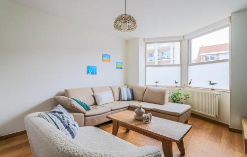 a living room with a couch and a table at Belle Villa Proche Plage in Bray-Dunes