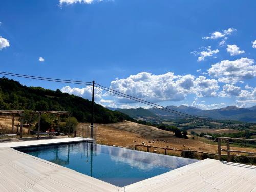 a swimming pool with a view of a mountain at Bed and Breakfast Agriturismo La Palombara 