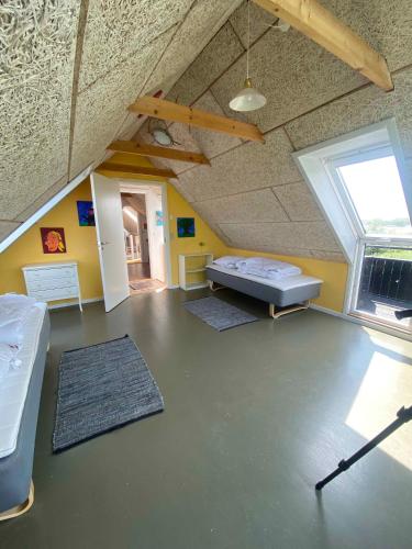 a large room with a bed and a window at Spacious Holiday Home With Views Over Limfjorden in Jørsby