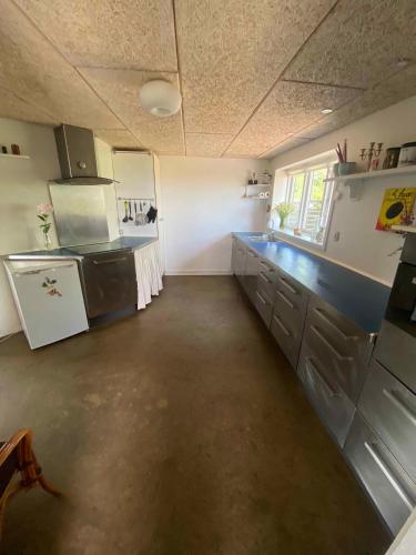 a large kitchen with blue counter tops in a room at Spacious Holiday Home With Views Over Limfjorden in Jørsby