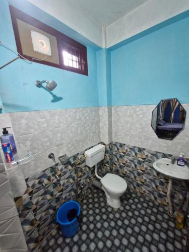 a bathroom with a toilet and a sink at The Urban Homestay Premium Floating Bed AC Room Free Parking in Dibrugarh
