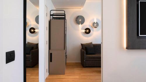 a living room with a refrigerator and a couch at I Portici Hotel Bologna in Bologna
